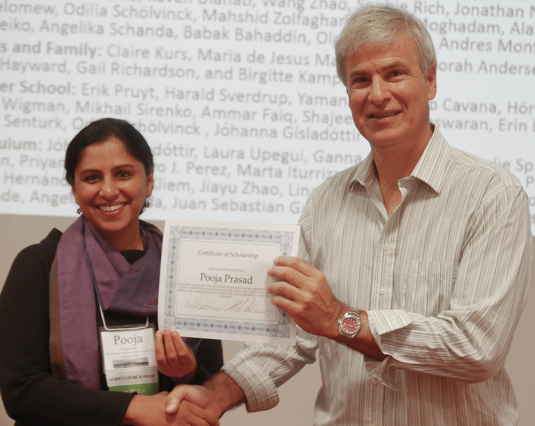 Pooja Prasad accepts Scholarship Award from Karim Chichakly